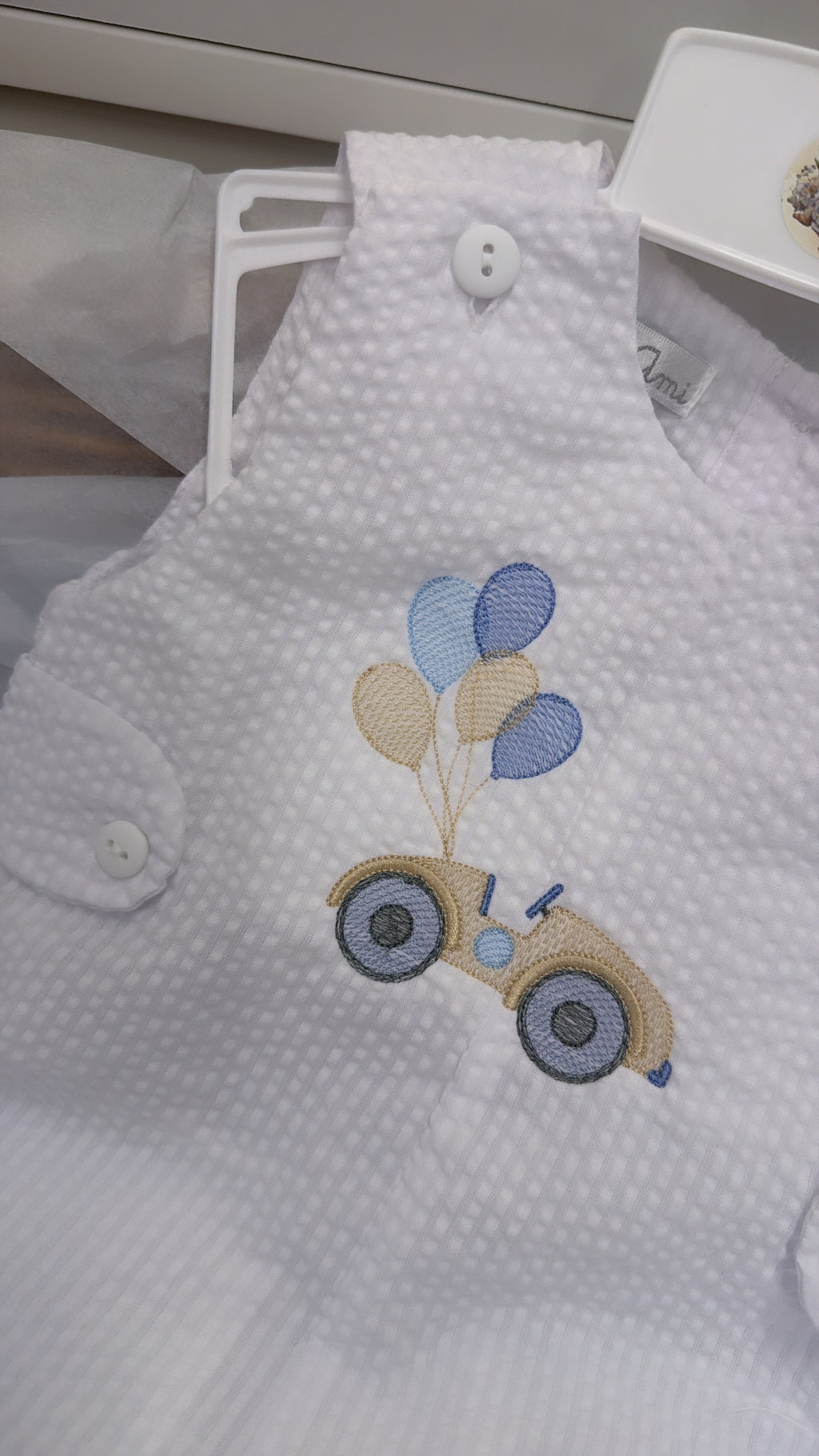 White playsuit with beige car and balloons