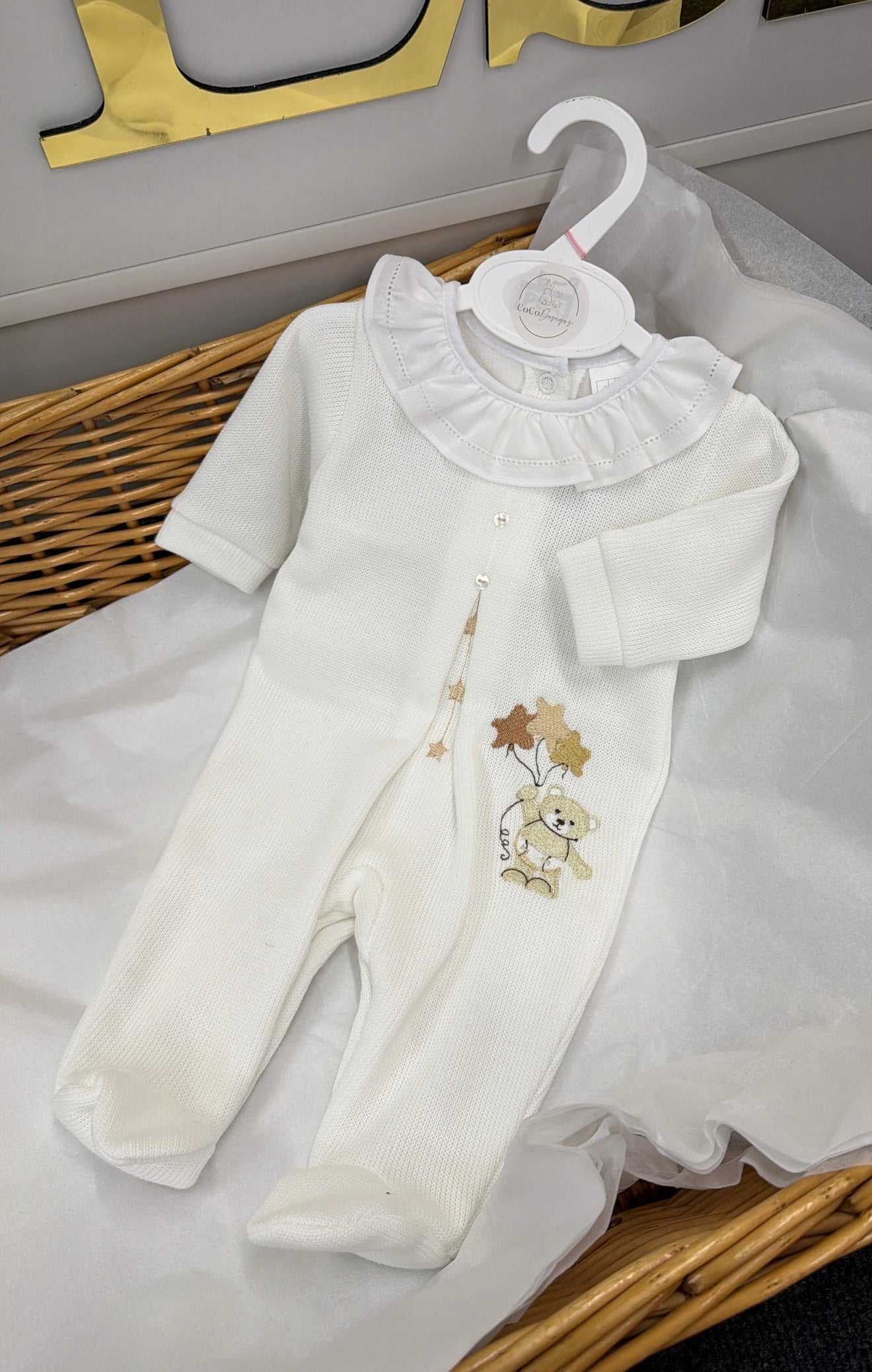 White knitted babygrow with bear