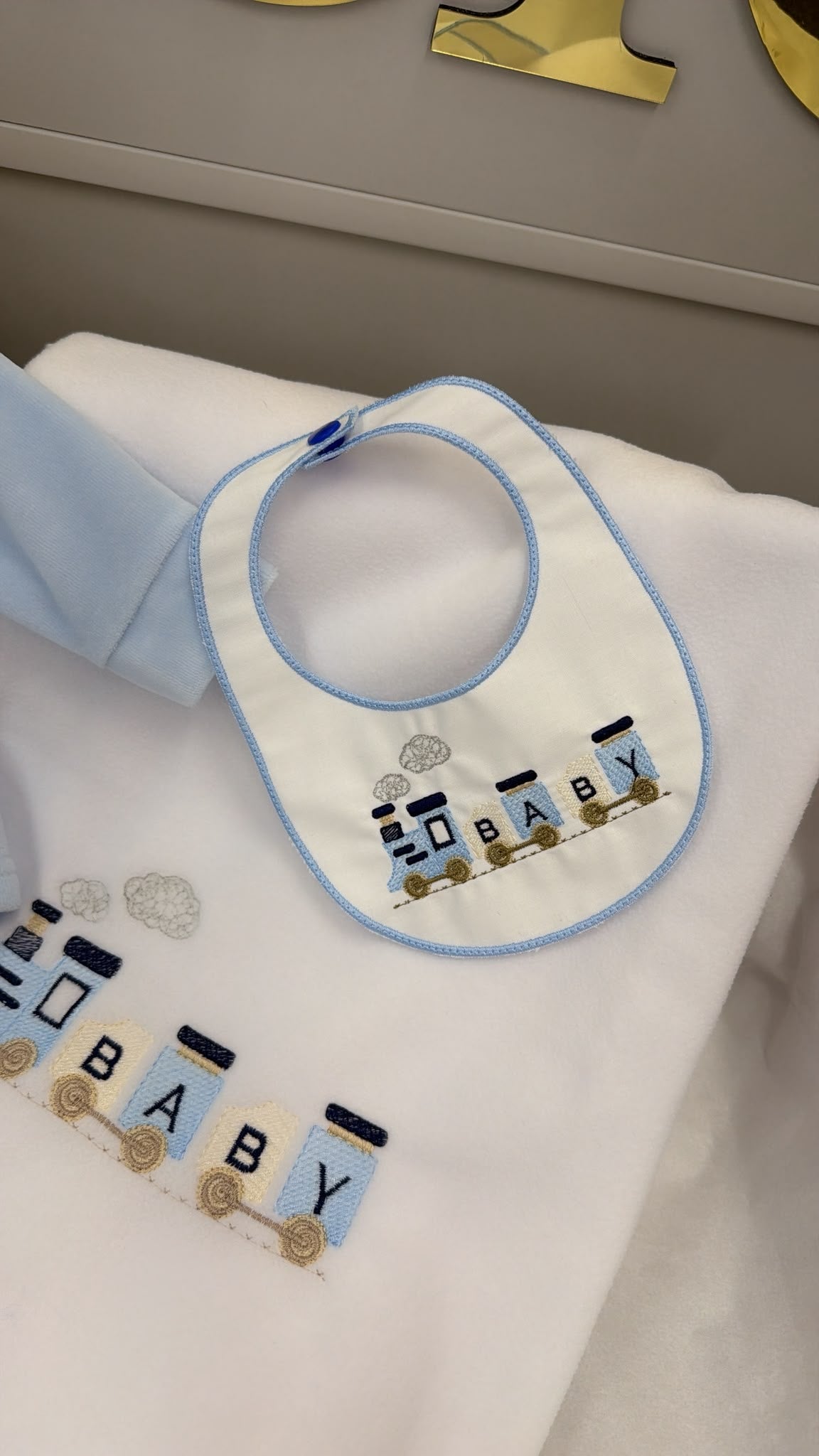 Baby train two piece outfit with matching bib and matching white fleece blanket