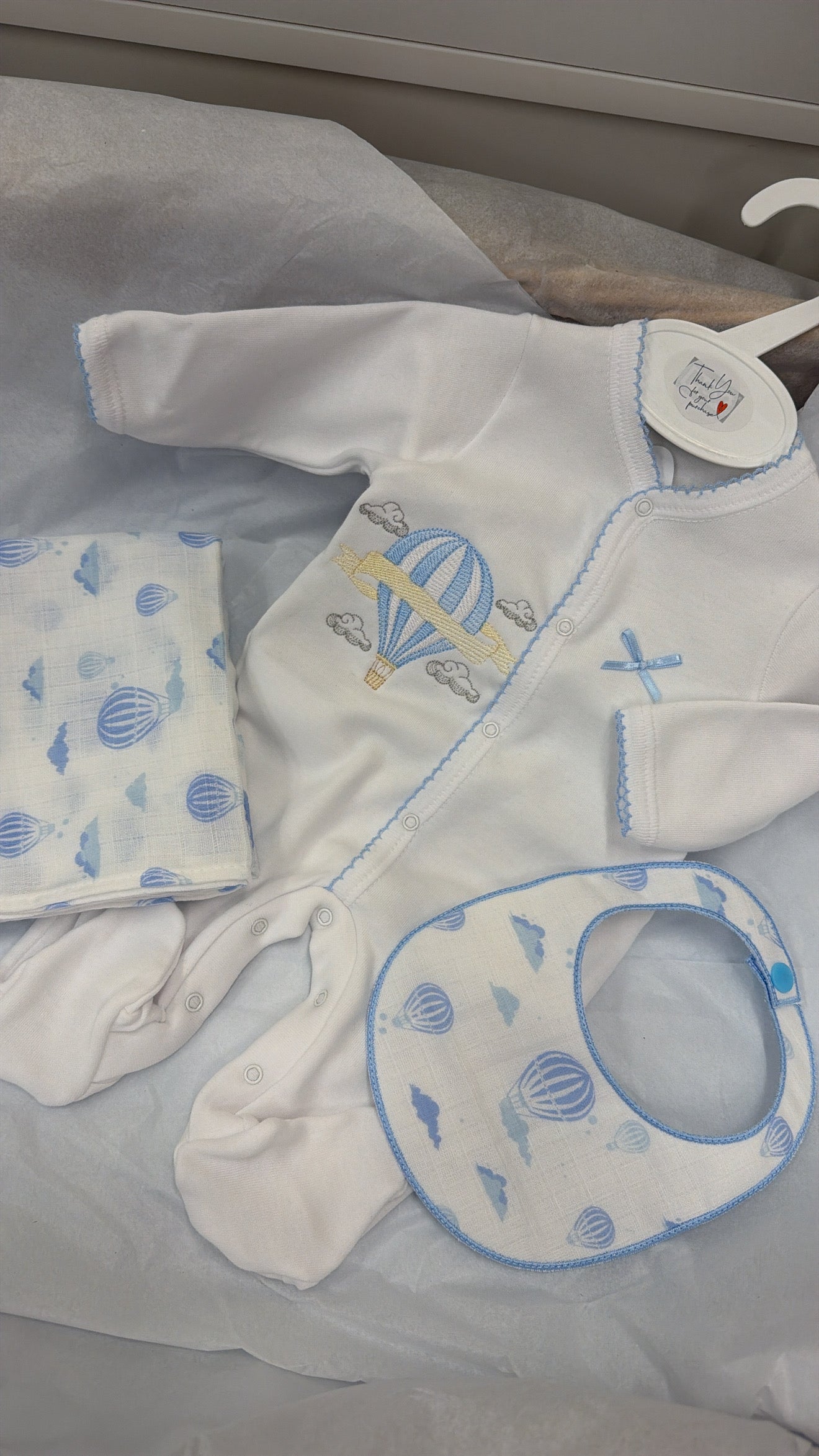 Blue trim hot air balloon babygrow,bib and muslin