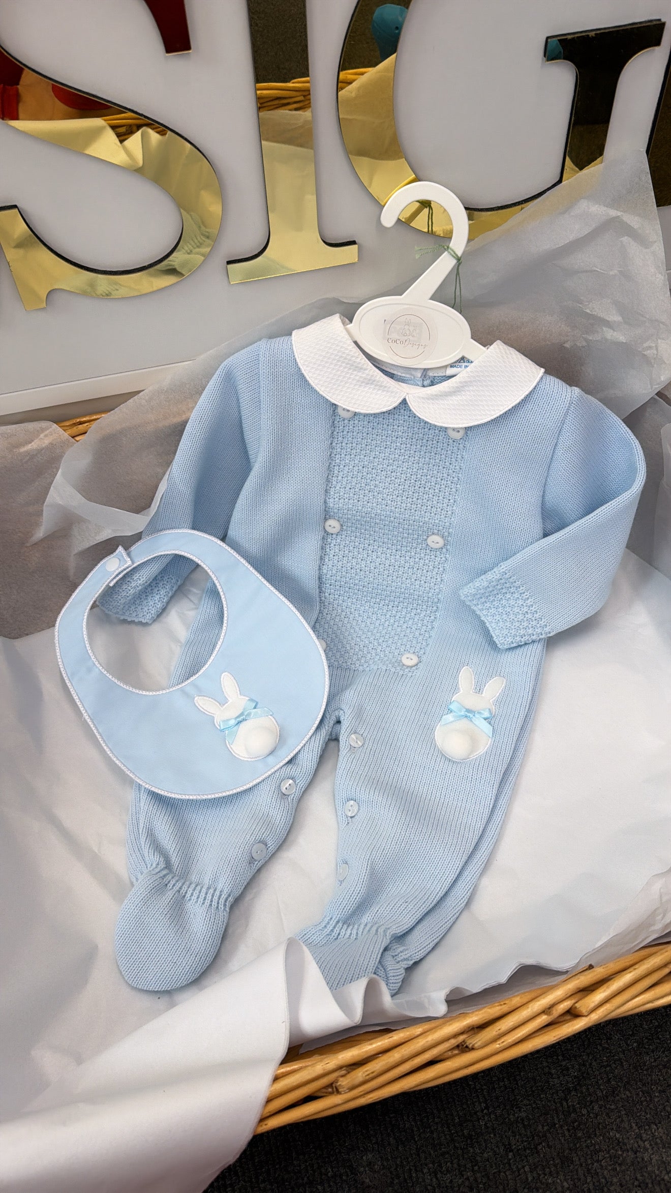 Blue knit babygrow and bib