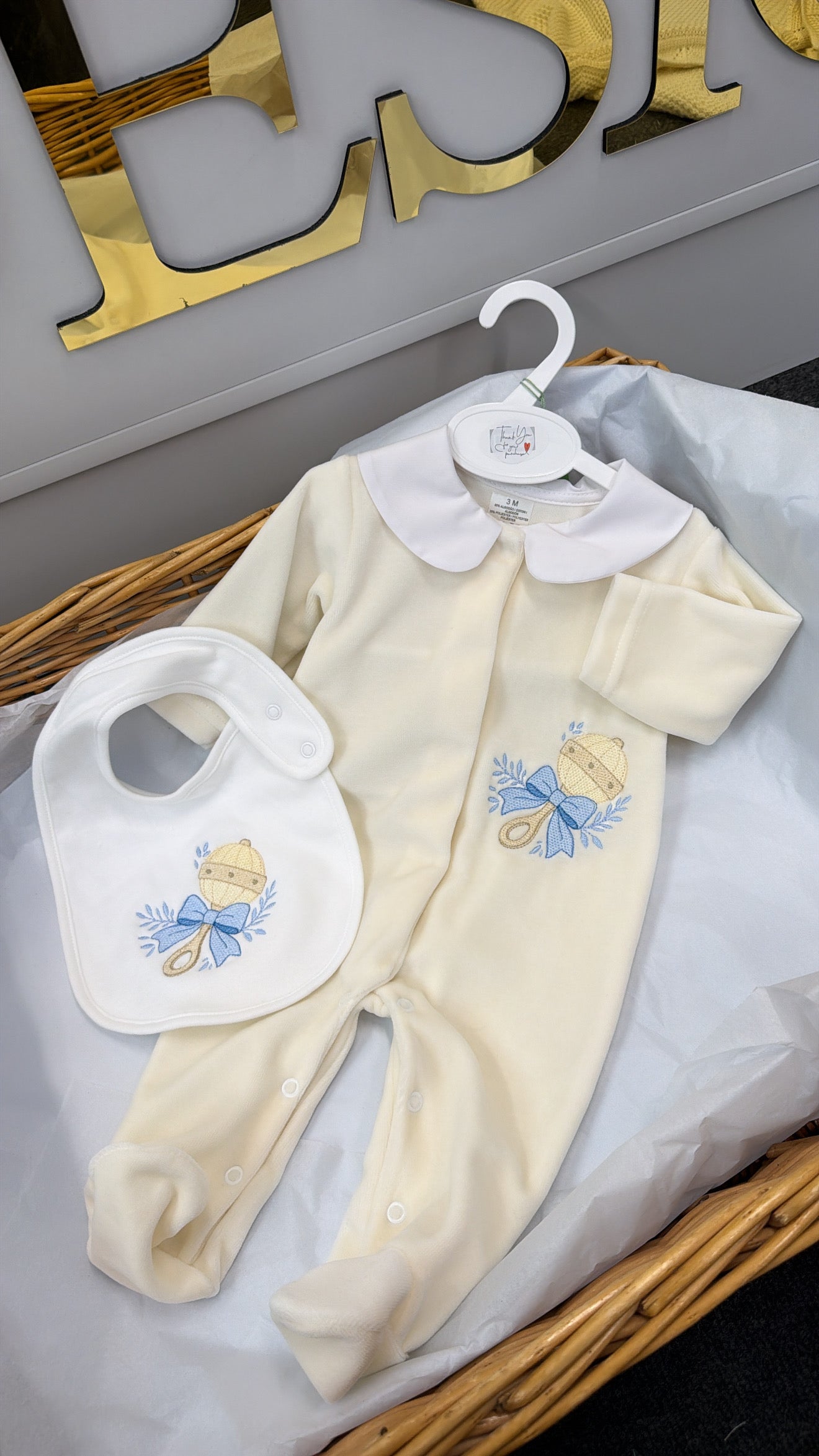 Blue and ivory rattle baby-grow